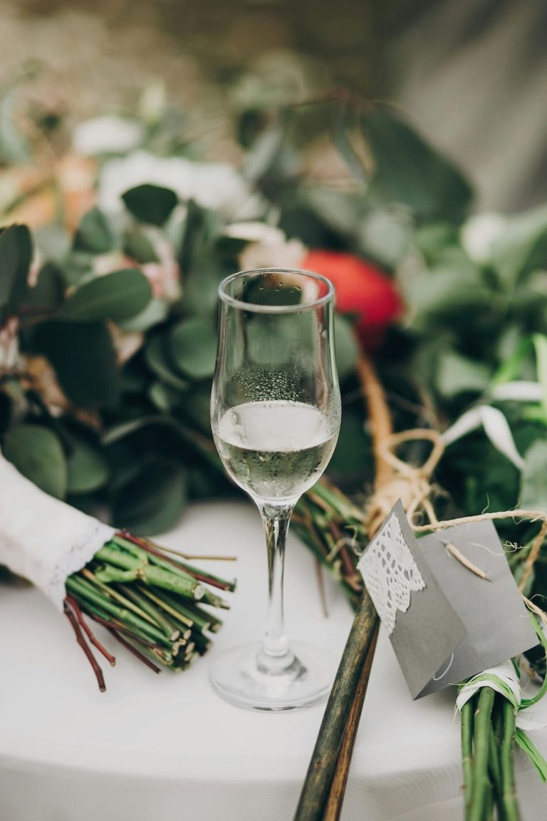 phot d'une coupe de champagne posés sur une table dresses avec des fleurs et plantes
