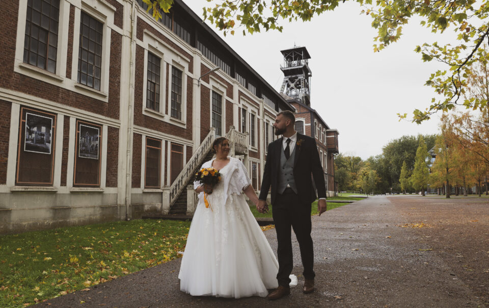 photographe mariage haut de france lens couple marié dans un site minier qui marchent main dans la main en se regardant